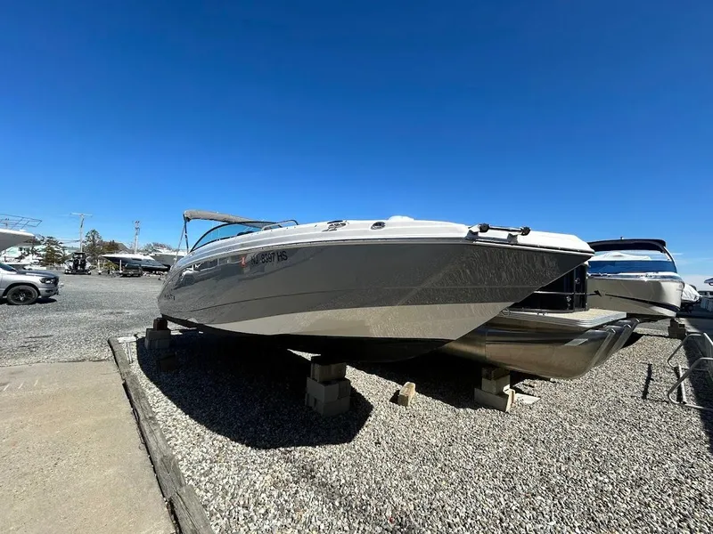 Slide: The Image of 2022 NauticStar 243DC Sport Deck boat on display under clear blue sky. - 4