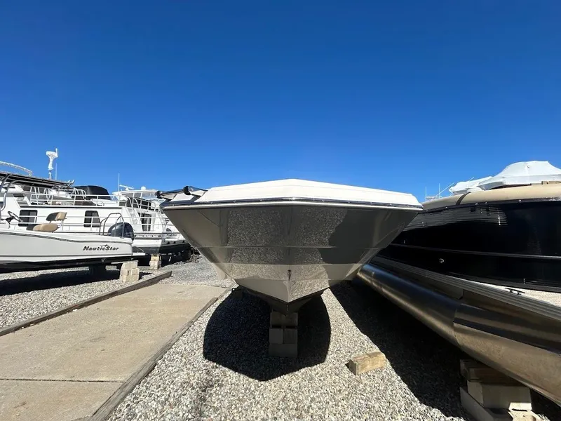 Slide: The Image of 2022 NauticStar 243DC Sport Deck boat on dry dock under clear blue sky. - 5