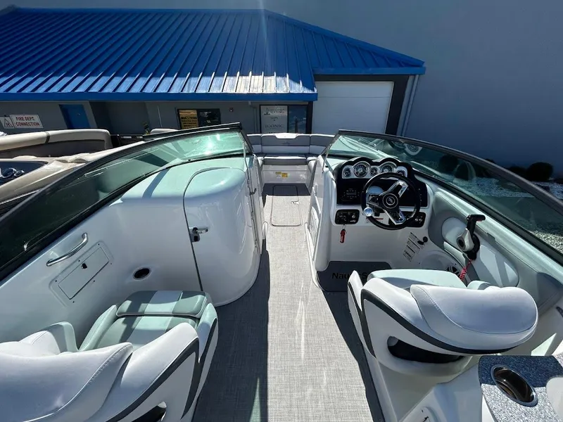 Slide: The Image of 2022 NauticStar 243DC Sport Deck boat interior with modern seating and controls. - 6