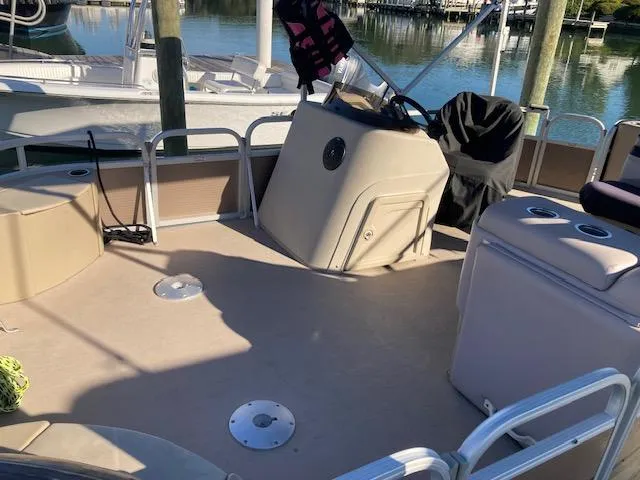 Slide: The Image of 2011 Bennington 20 GL pontoon boat interior with helm, seating, and water view. - 6