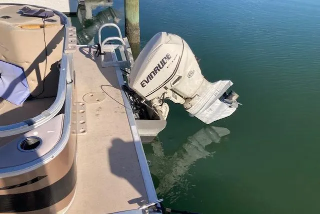 Slide: The Image of 2011 Bennington 20 GL pontoon boat with Evinrude outboard motor on calm water. - 7