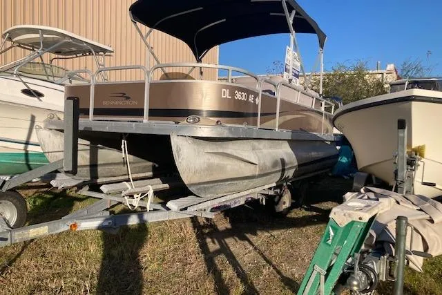 Slide: The Image of 2011 Bennington 20 GL pontoon boat on trailer, parked outdoors in sunlight. - 9