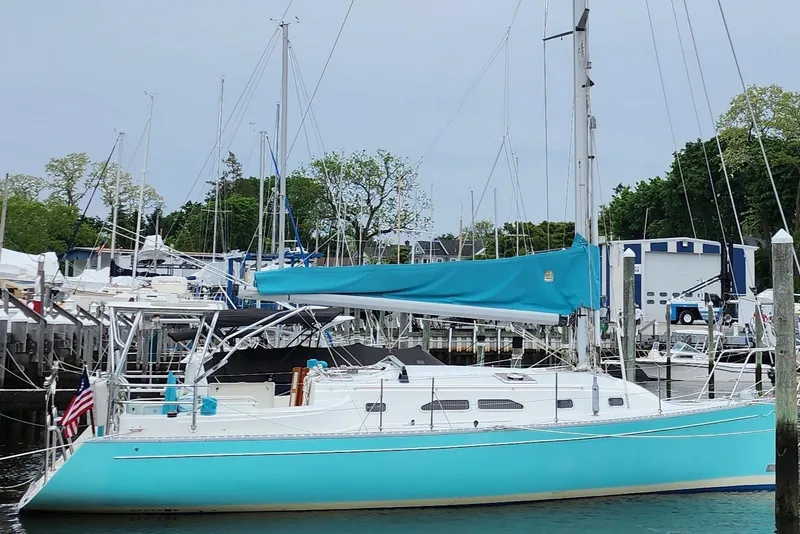 The Image of Turquoise 2005 Shannon Shoalsailer yacht docked in a marina with other sailboats. - 0