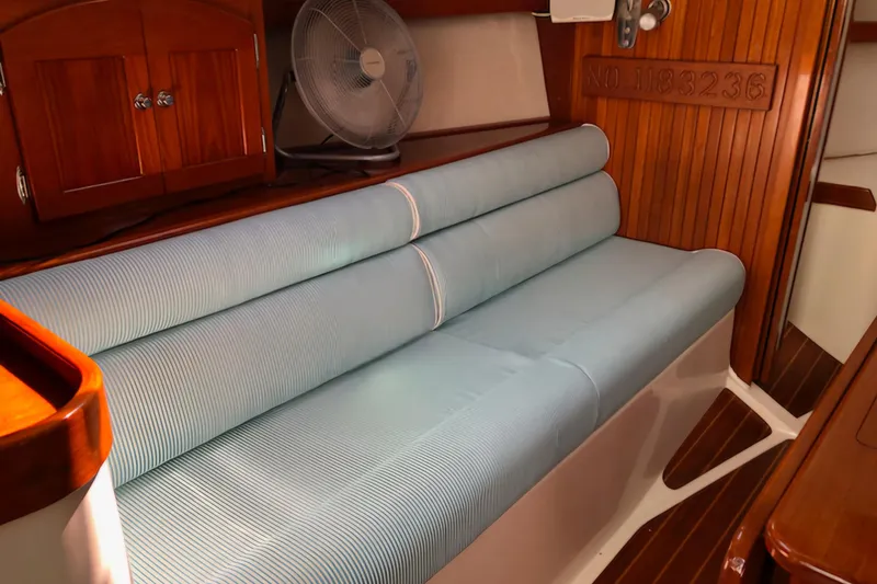 Slide: The Image of Interior of 2005 Shannon Shoalsailer with blue cushioned seating and wooden accents. - 12