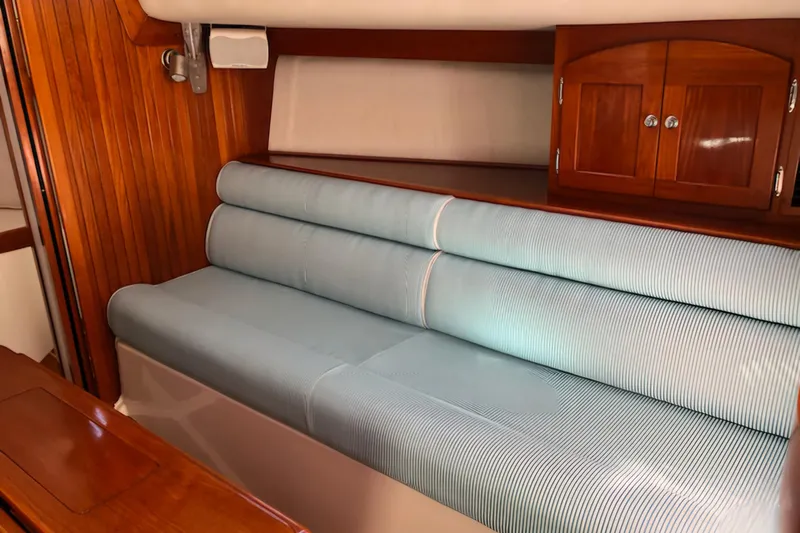 Slide: The Image of Interior of 2005 Shannon Shoalsailer with striped seating and wooden cabinetry. - 14