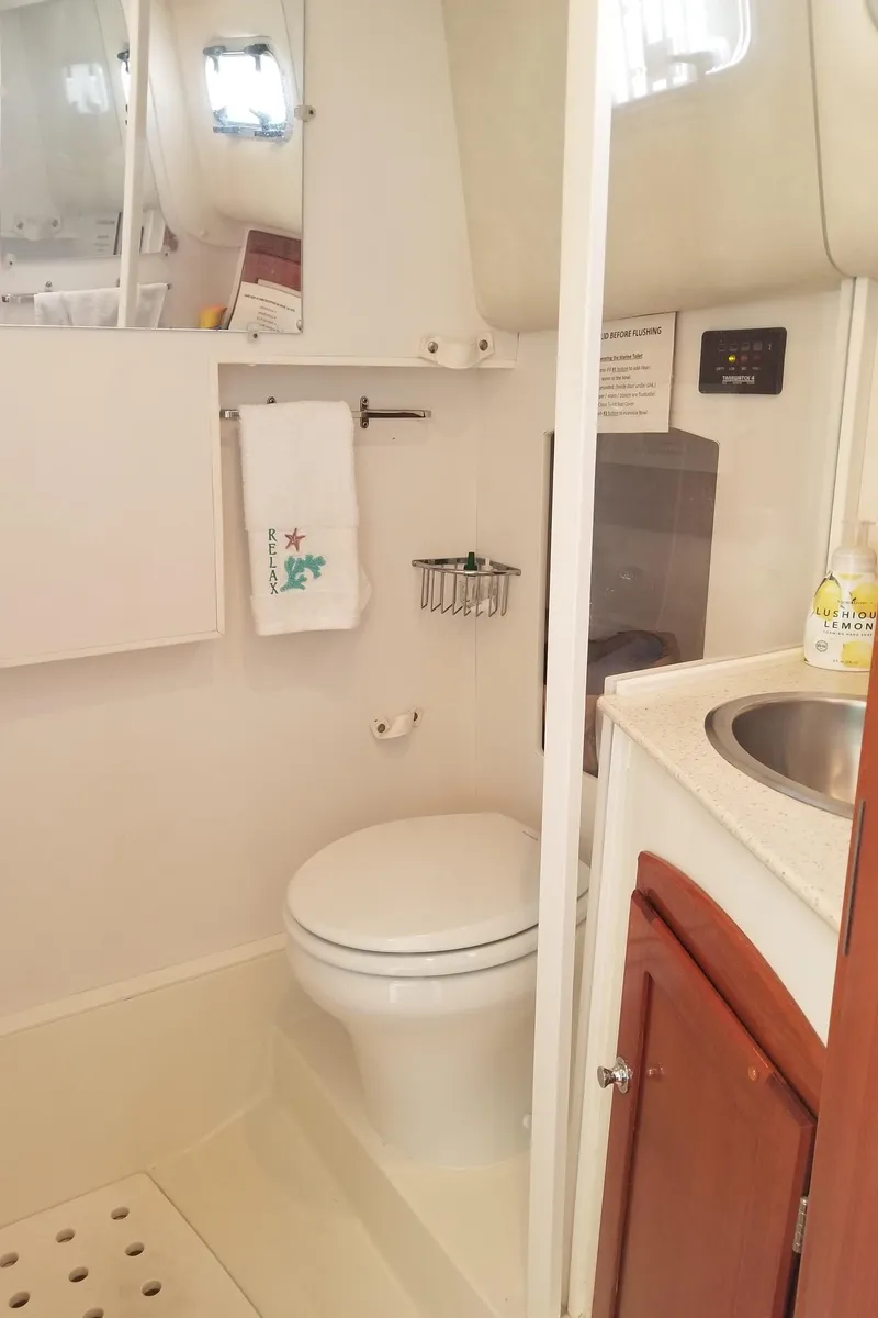 Slide: The Image of 2005 Shannon Shoalsailer bathroom with toilet, sink, and storage cabinet. - 18
