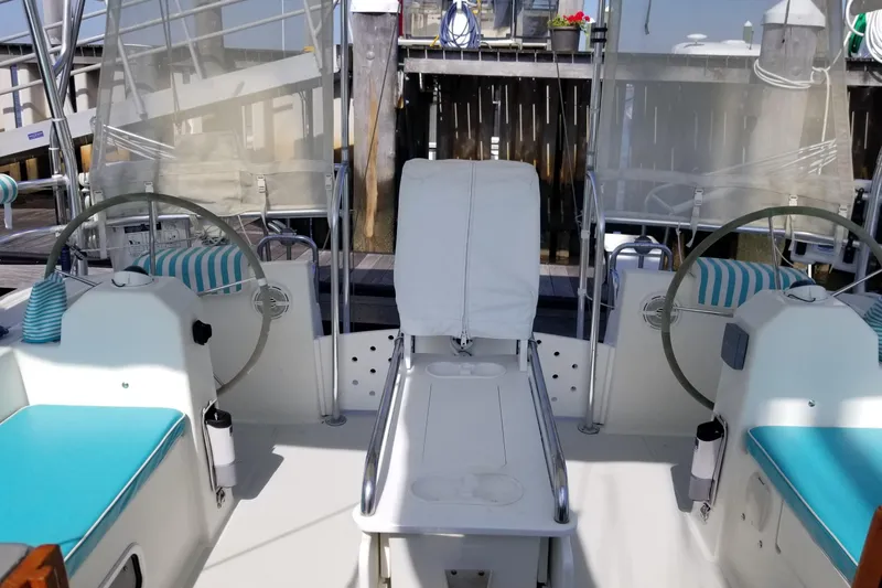 Slide: The Image of 2005 Shannon Shoalsailer cockpit with dual steering wheels and blue cushioned seats. - 2