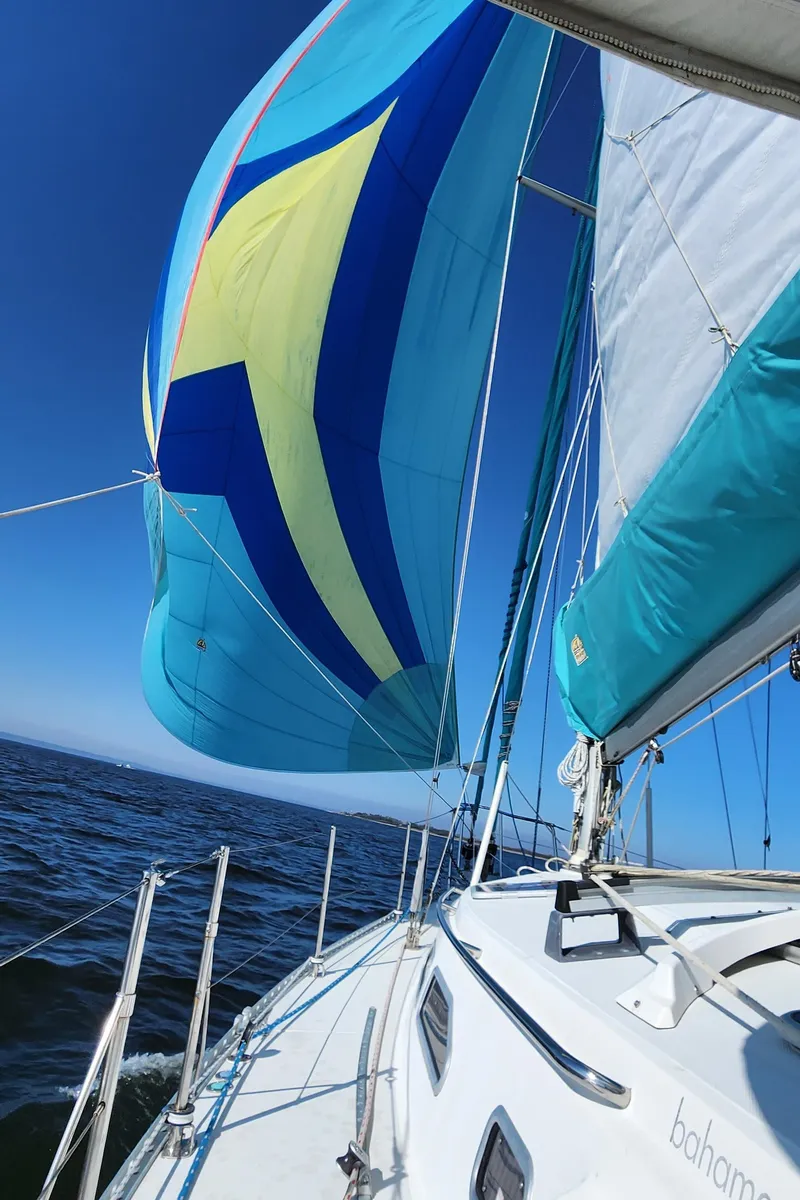 Slide: The Image of Sailing on a 2005 Shannon Shoalsailer with vibrant blue and yellow sails. - 20