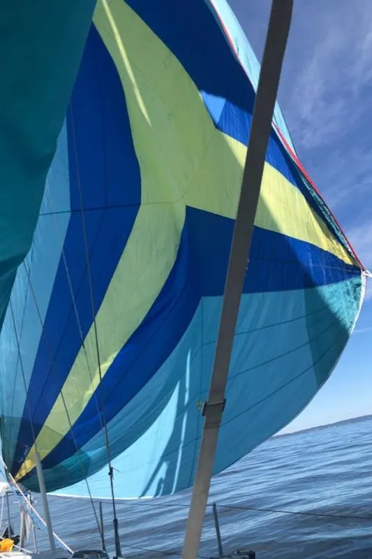 Slide: The Image of Sailboat with colorful spinnaker sail on a calm sea, Shannon Shoalsailer 2005. - 21