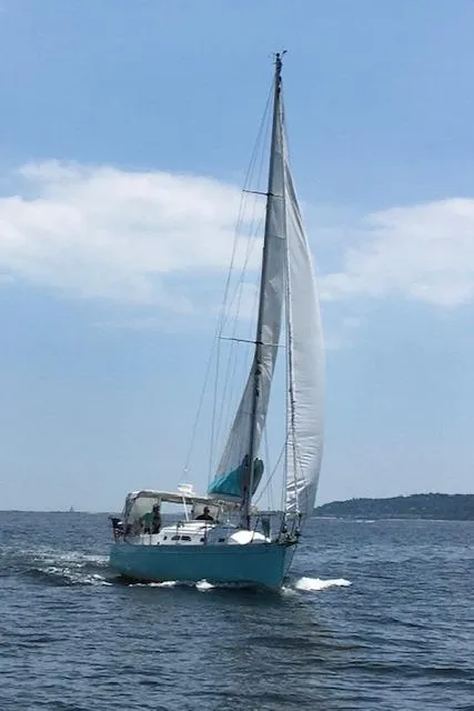 Slide: The Image of Sailboat Shannon Shoalsailer 2005 navigating on open water under clear blue sky. - 23