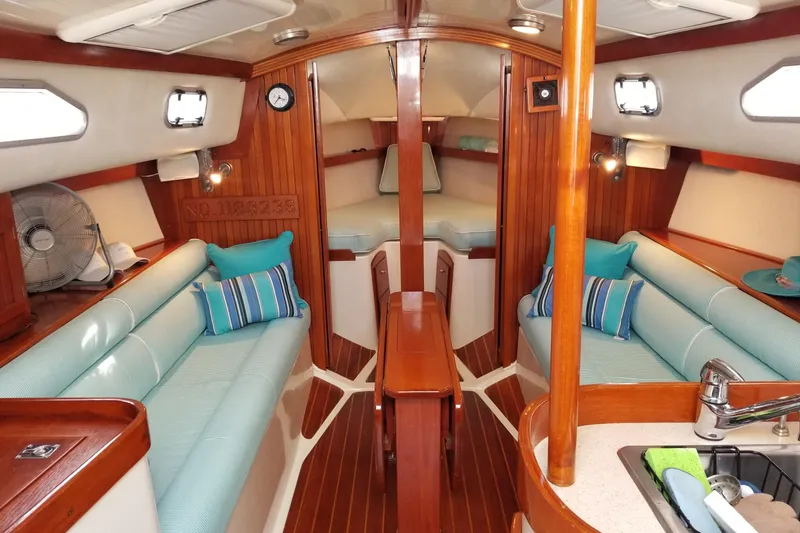 Slide: The Image of Luxurious 2005 Shannon Shoalsailer interior with wood finish, cozy seating, and nautical decor. - 3
