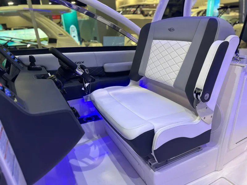 Slide: The Image of 2025 Chaparral 310 OSX boat interior with modern helm and luxurious seating. - 13