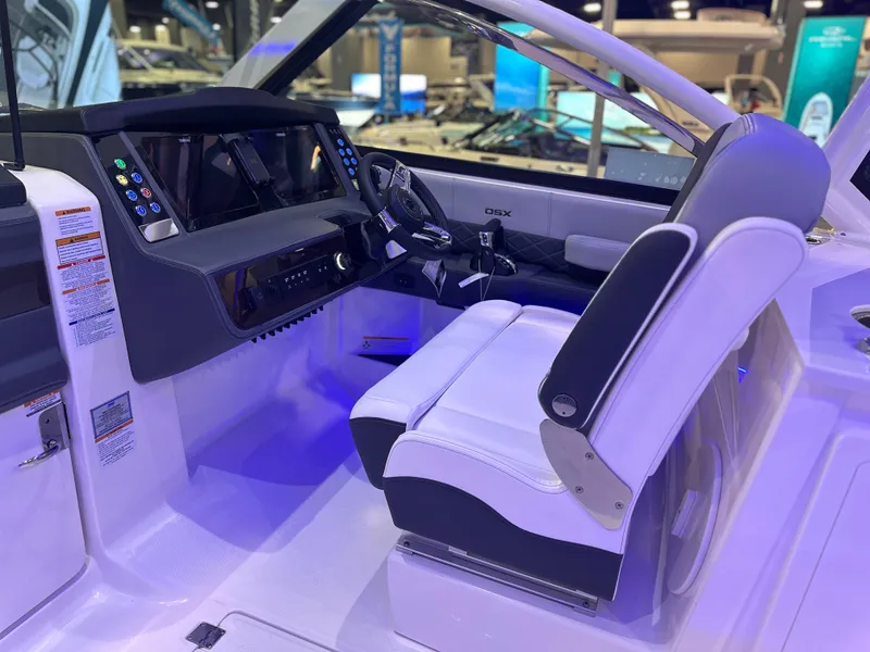 Slide: The Image of 2025 Chaparral 310 OSX boat interior with modern dashboard and seating. - 14