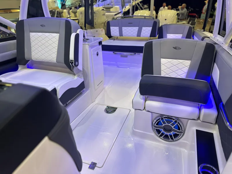 Slide: The Image of 2025 Chaparral 310 OSX boat interior with modern seating and ambient lighting. - 16