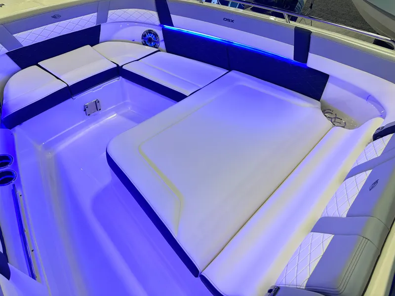 Slide: The Image of 2025 Chaparral 310 OSX boat interior with blue LED lighting and luxurious seating. - 20