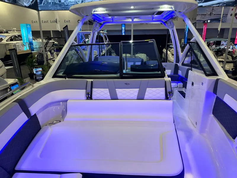 Slide: The Image of 2025 Chaparral 310 OSX boat interior with modern seating and ambient lighting. - 21