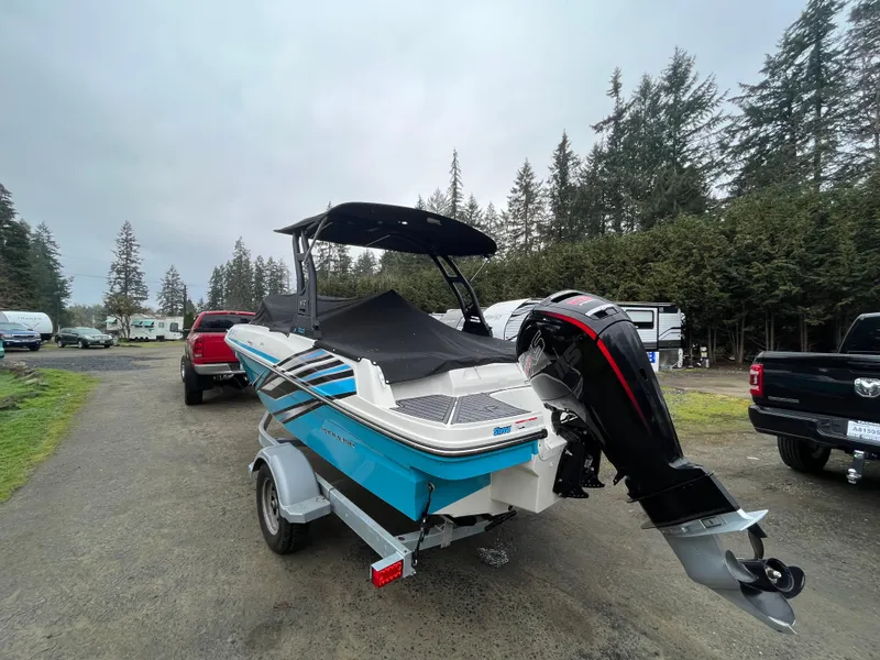 Slide: The Image of 2023 Bayliner VR4 Bowrider OB on trailer, parked outdoors near trees. - 17