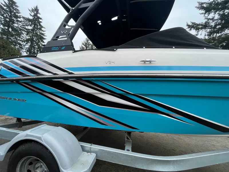 Slide: The Image of 2023 Bayliner VR4 Bowrider OB with blue and black graphics on a trailer. - 21