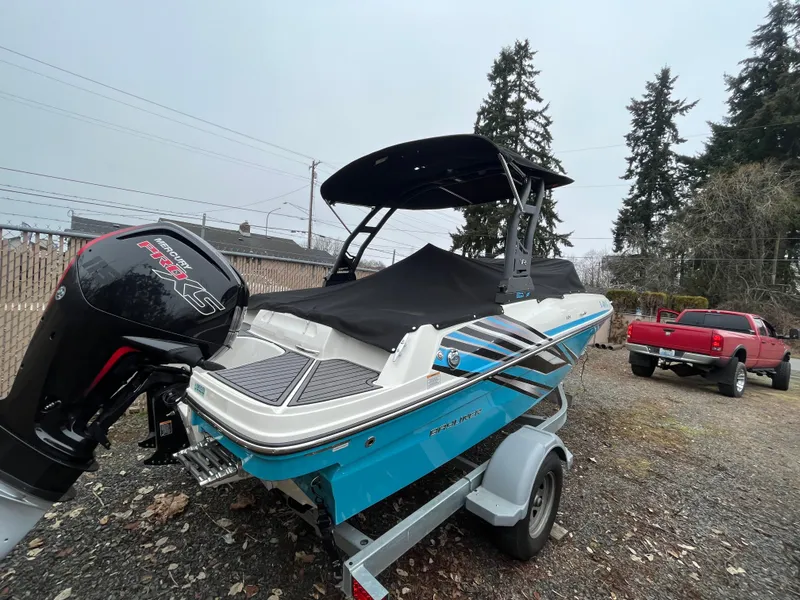 Slide: The Image of 2023 Bayliner VR4 Bowrider OB on trailer, with outboard motor, parked outdoors. - 28