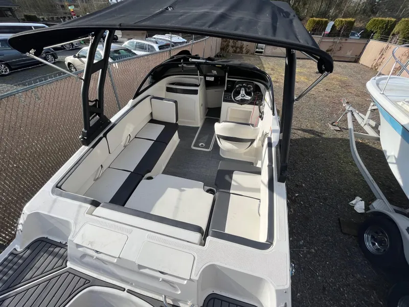 Slide: The Image of 2023 Bayliner VR4 Bowrider OB with spacious seating and canopy, parked outdoors. - 30