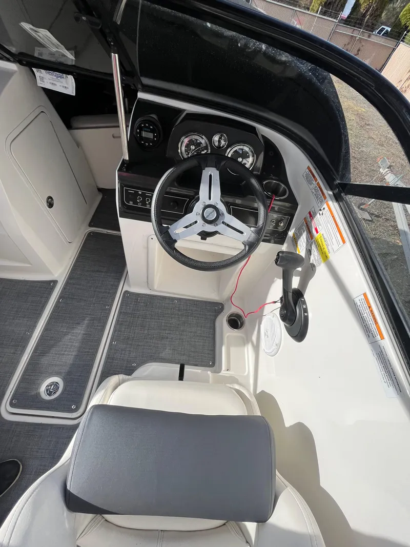 Slide: The Image of 2023 Bayliner VR4 Bowrider OB cockpit with steering wheel and control panel. - 32