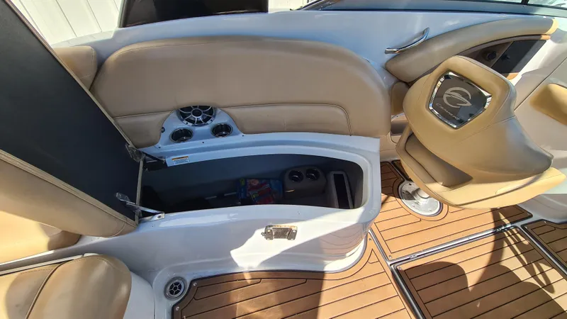 Slide: The Image of 2018 Crownline Eclipse E24 XS interior with tan seating and storage compartment. - 14