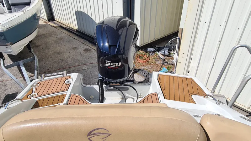 Slide: The Image of 2018 Crownline Eclipse E24 XS boat with Yamaha 250 outboard motor, docked near a storage facility. - 17