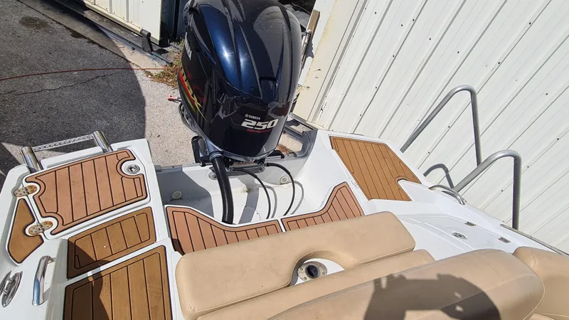 Slide: The Image of 2018 Crownline Eclipse E24 XS boat with 250 HP outboard motor and teak-style decking. - 19