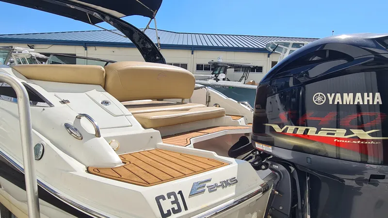 Slide: The Image of 2018 Crownline Eclipse E24 XS boat with Yamaha VMAX engine, docked under clear blue sky. - 20