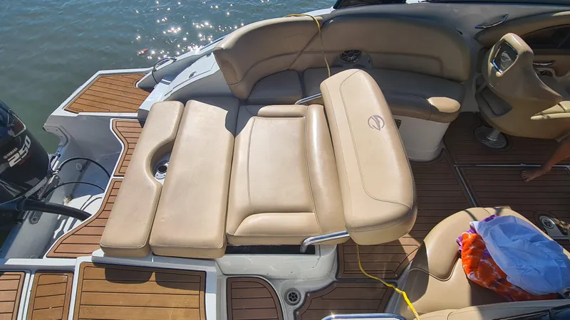 Slide: The Image of 2018 Crownline Eclipse E24 XS boat interior with tan seating and wood accents. - 21