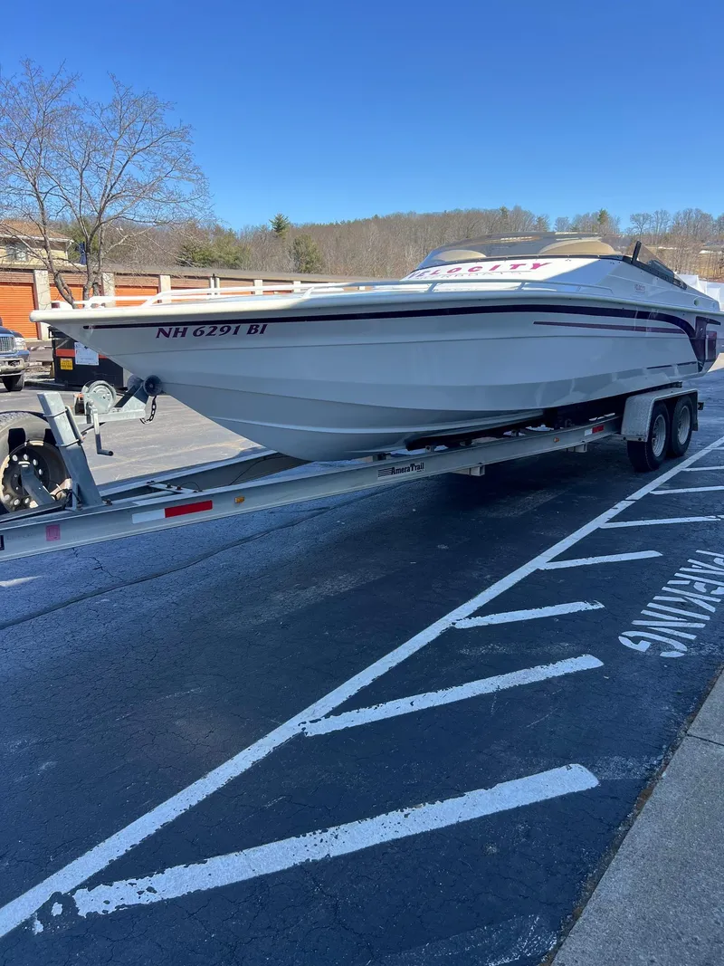 Slide: The Image of 1998 Velocity 260 boat on trailer in parking lot. - 12