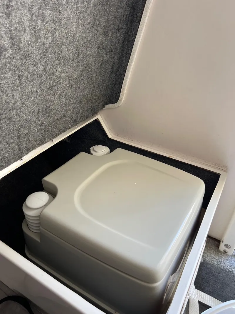 Slide: The Image of Portable toilet in a 1998 Velocity 260 boat compartment. - 15