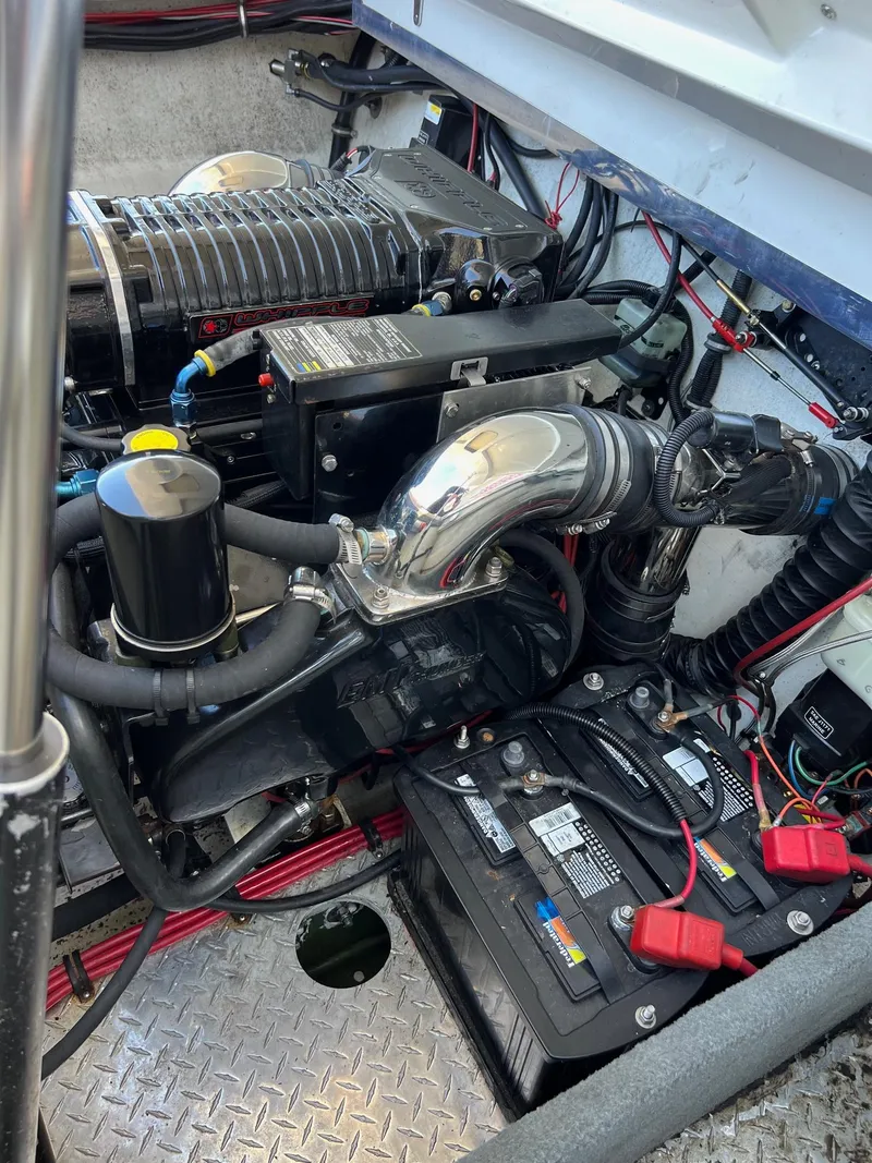 Slide: The Image of Engine compartment of a 1998 Velocity 260 boat, featuring battery and wiring components. - 21