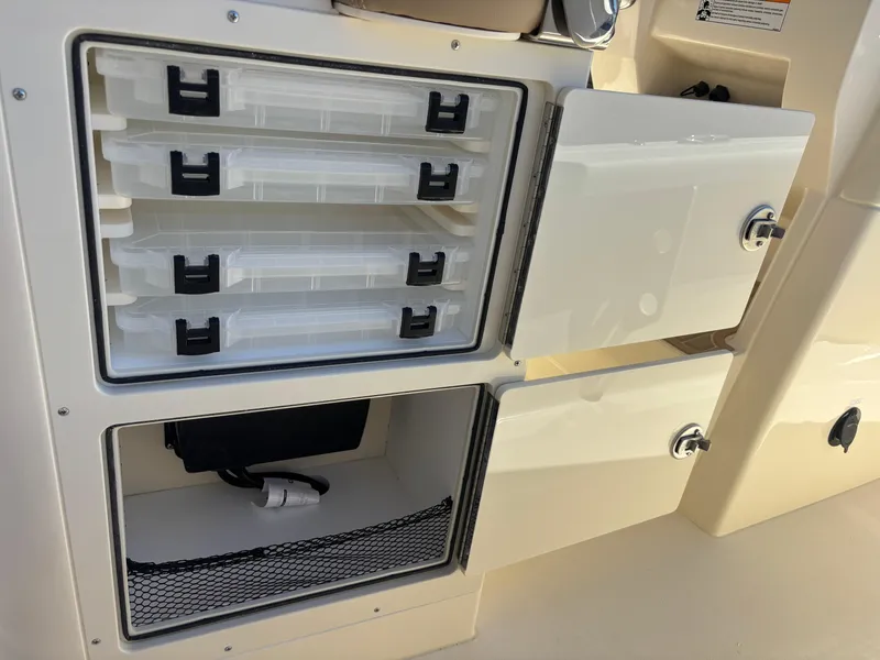 Slide: The Image of 2025 Scout 261 XSS boat interior bathroom with toilet and window. - 13