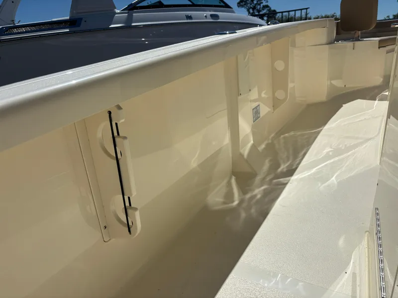 Slide: The Image of Open storage compartment on 2025 Scout 261 XSS boat deck. - 18