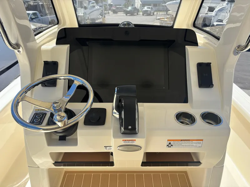 Slide: The Image of 2025 Scout 261 XSS boat with beige seating and Mercury engine. - 6