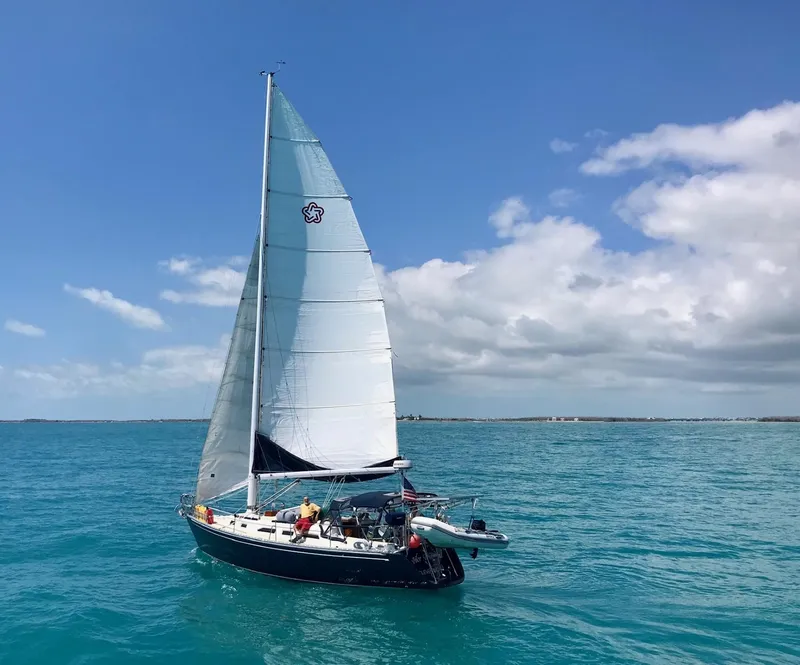 Slide: The Image of Sailboat Freedom F-38, 1991 model, cruising on clear blue ocean under a sunny sky. - 1