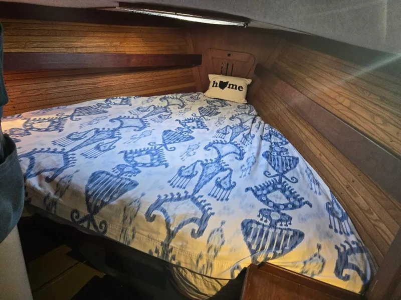 Slide: The Image of Cozy cabin bed in 1991 Freedom F-38 sailboat with nautical-themed bedding. - 13