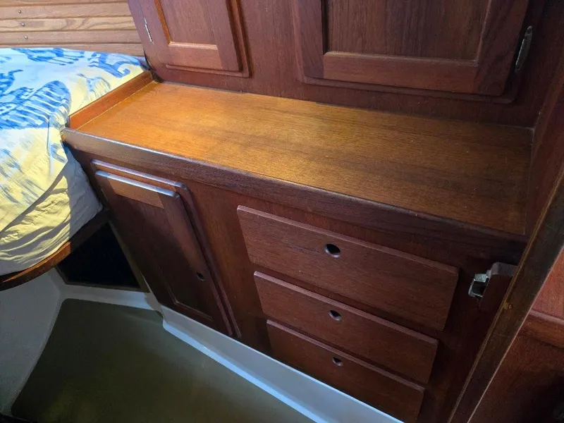 Slide: The Image of Wooden cabinetry in a 1991 Freedom F-38 boat interior, featuring drawers and a bed. - 17