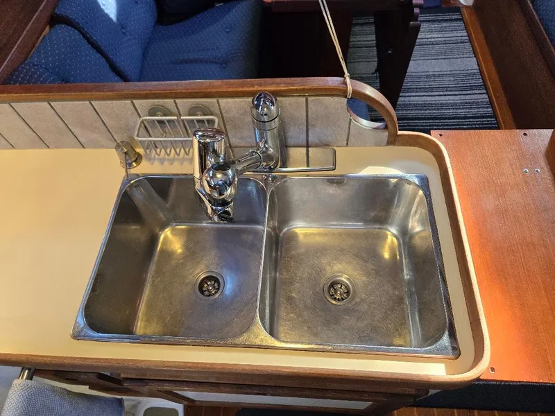 Slide: The Image of Stainless steel double sink in a 1991 Freedom F-38 boat kitchen. - 31