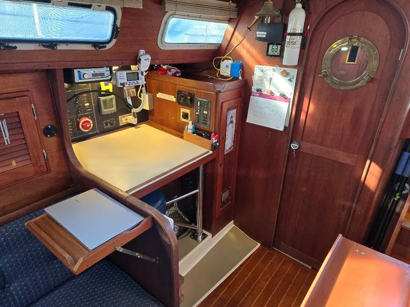 Slide: The Image of Interior of 1991 Freedom F-38 sailboat with navigation station and wooden cabinetry. - 38