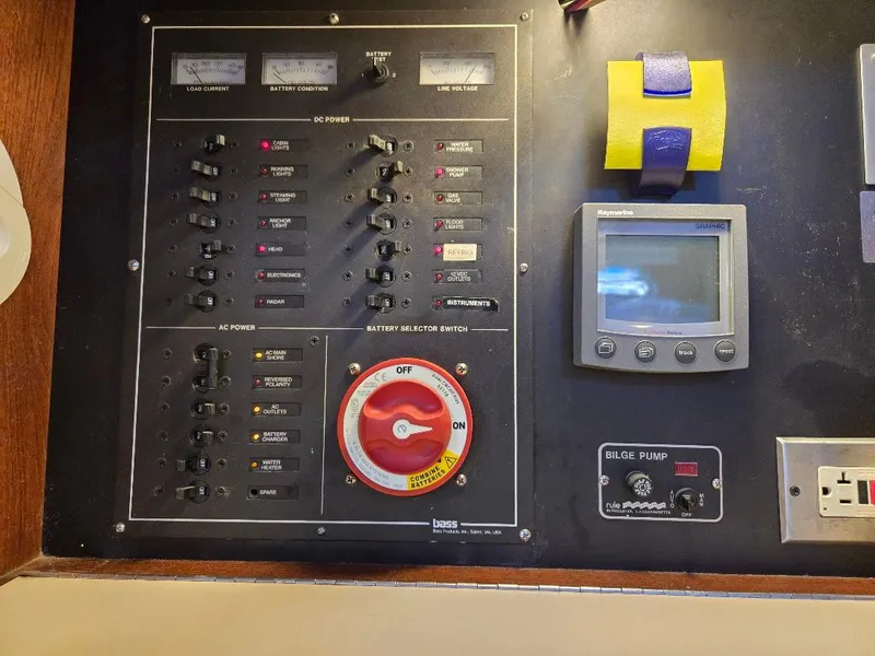 Slide: The Image of Electrical control panel on a 1991 Freedom F-38 boat with various switches and gauges. - 43
