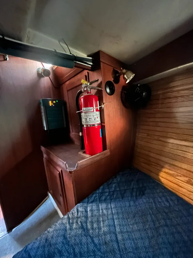 Slide: The Image of 1991 Freedom F-38 interior with fire extinguisher and wooden paneling. - 46