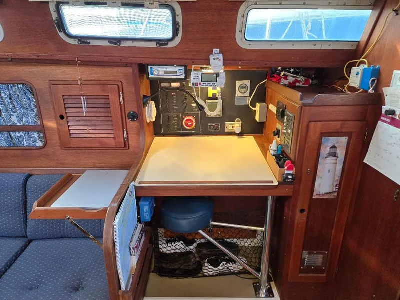 Slide: The Image of Navigation station inside a 1991 Freedom F-38 sailboat, featuring control panels and storage. - 5