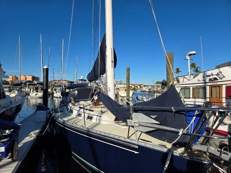 Slide: The Image of 1991 Freedom F-38 sailboat docked at a marina under clear blue skies. - 52