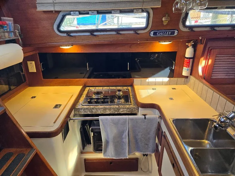 Slide: The Image of 1991 Freedom F-38 yacht kitchen with stove, sink, and storage. - 6