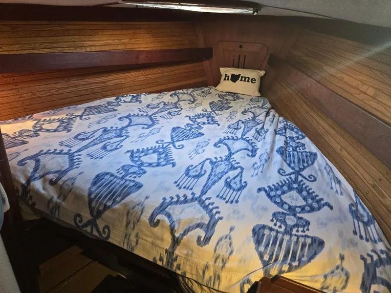 Slide: The Image of Cozy cabin bed in 1991 Freedom F-38 sailboat with nautical-themed bedding. - 7