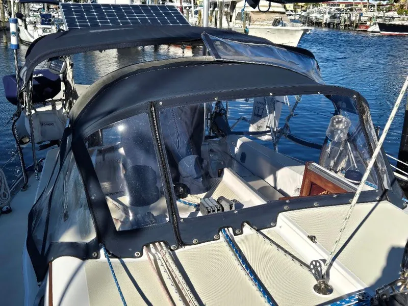 Slide: The Image of Sailboat Freedom F-38, 1991 model, docked with clear canopy and solar panels. - 8