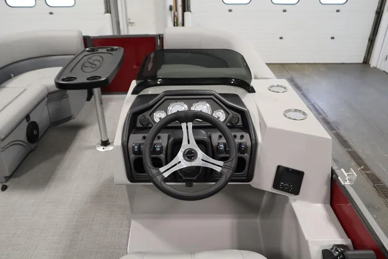Slide: The Image of 2025 Bentley Pontoons 200 CRUISE interior with steering wheel and seating area. - 19