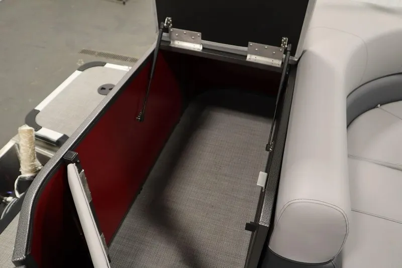 Slide: The Image of 2025 Bentley Pontoons 200 CRUISE storage compartment with open lid and cushioned seating. - 33